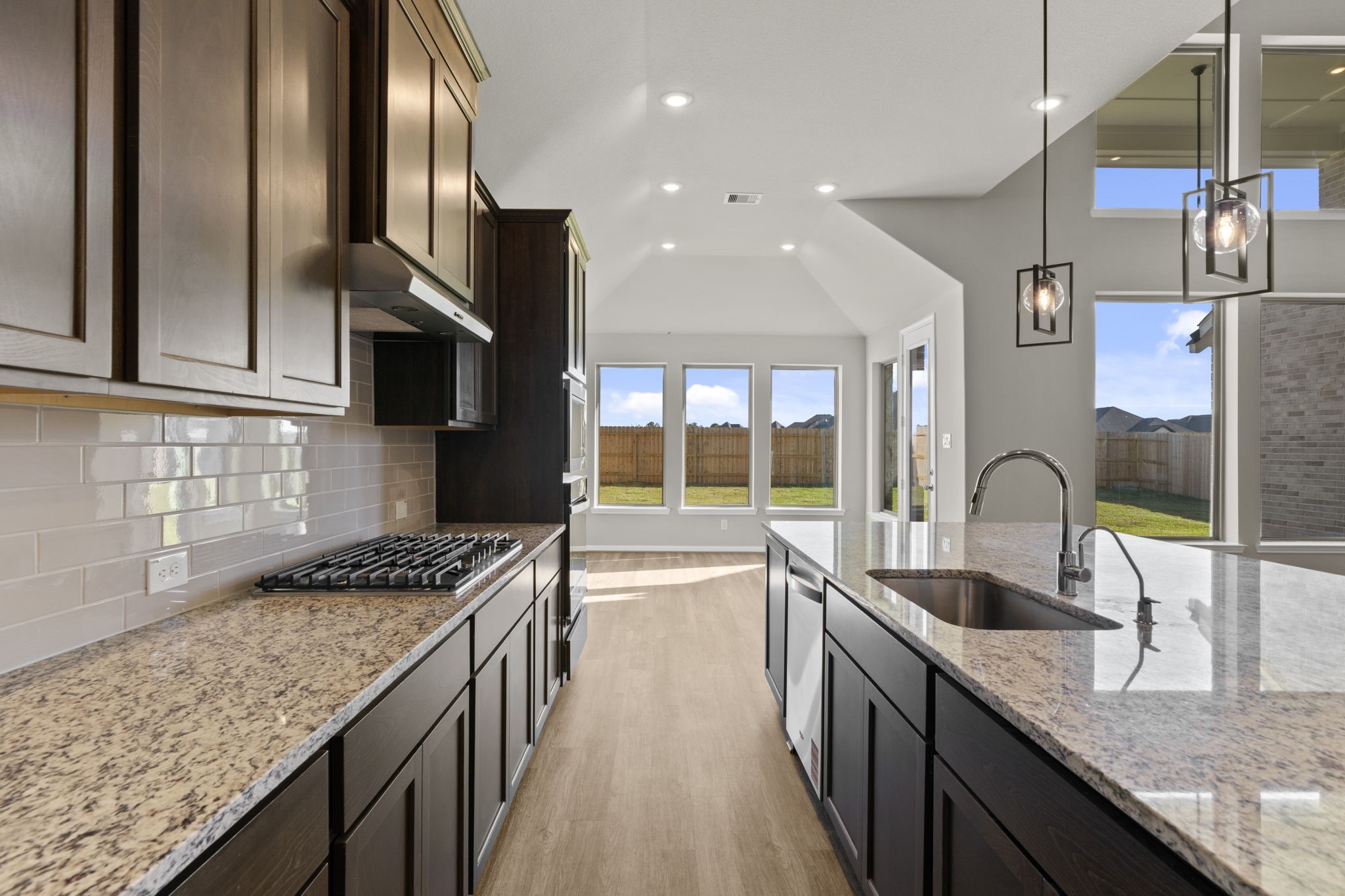 3324 Bentwood Ranch Drive Conroe, TX 77385 - Photo 6 of 35 a kitchen with stainless steel appliances granite countertop a sink a stove and a wooden floors