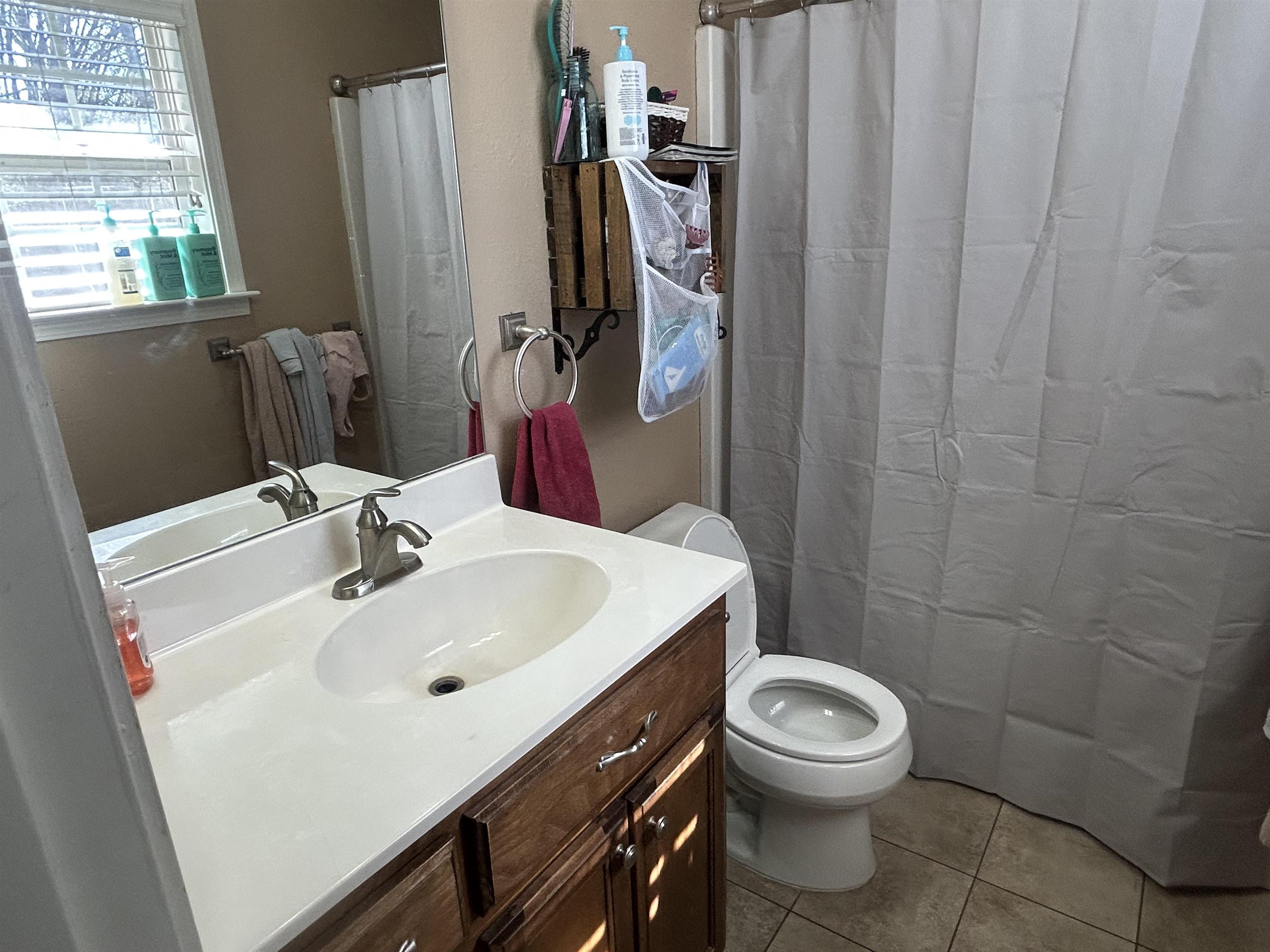 1535 Roane Street Covington, TN 38019 - Photo 13 of 25 Full bathroom featuring vanity, a shower with curtain, and light tile patterned floors