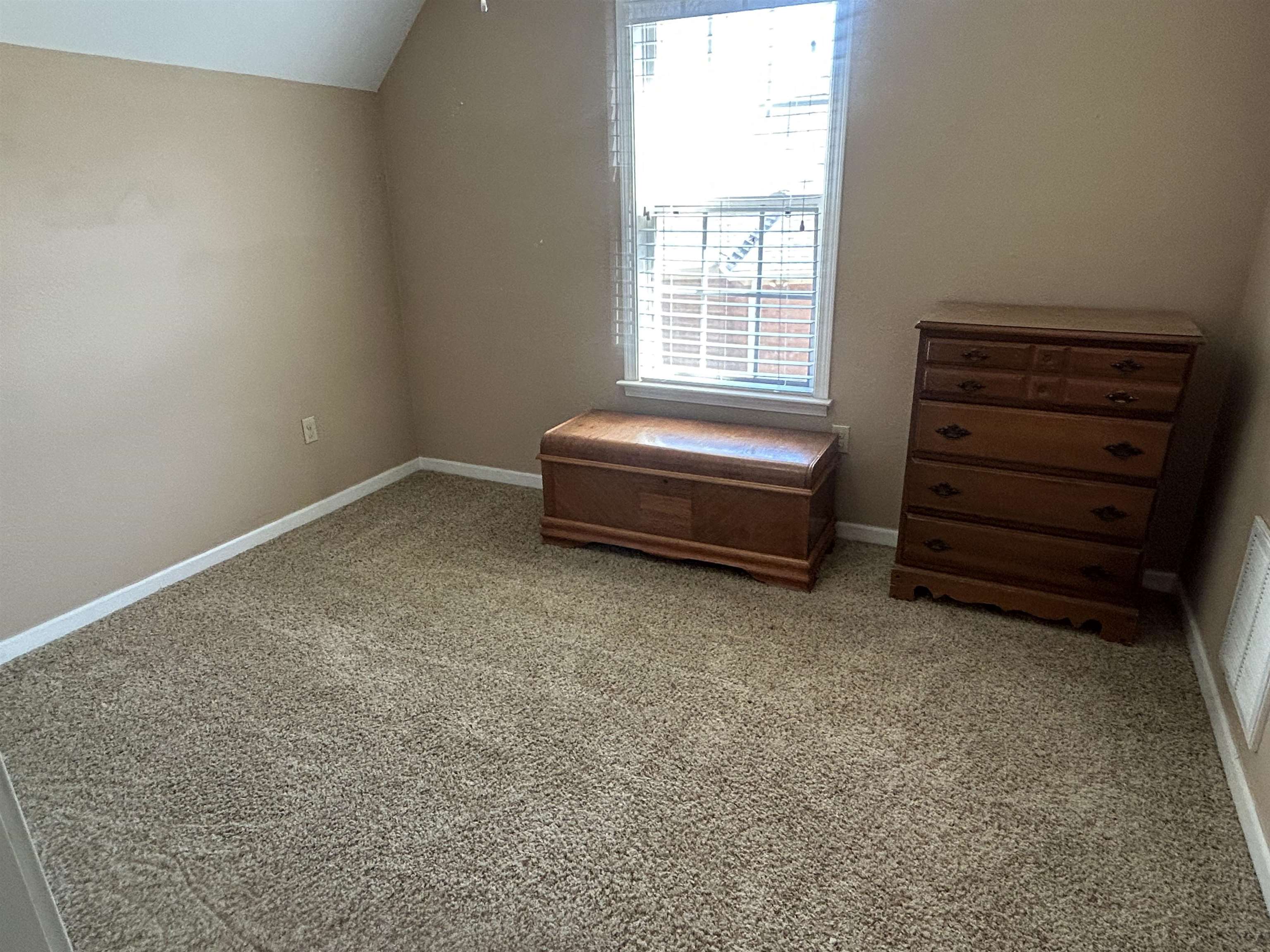 1535 Roane Street Covington, TN 38019 - Photo 18 of 25 Bonus room featuring light carpet and vaulted ceiling