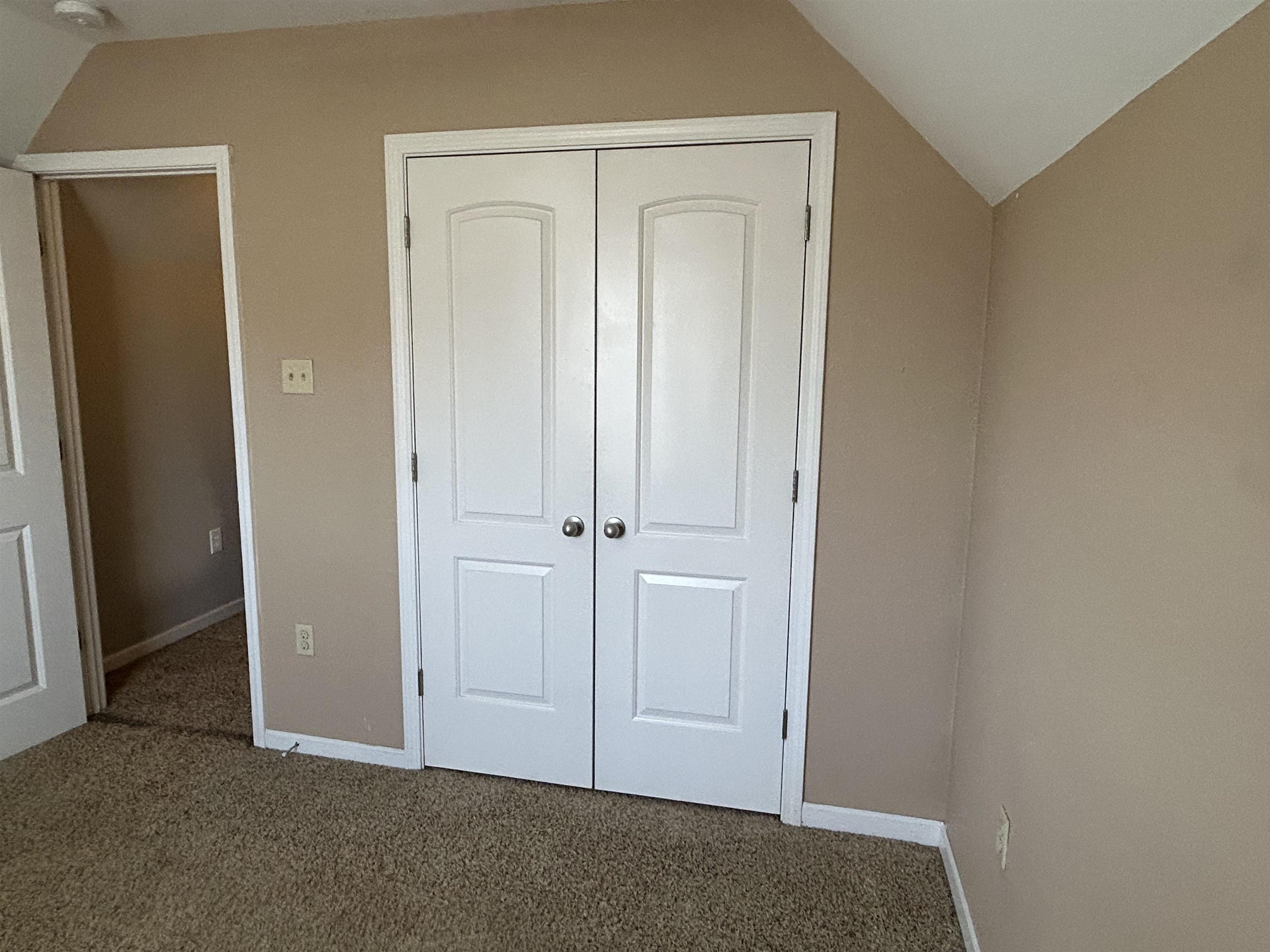 1535 Roane Street Covington, TN 38019 - Photo 19 of 25 Unfurnished bedroom featuring lofted ceiling, carpet floors, and a closet