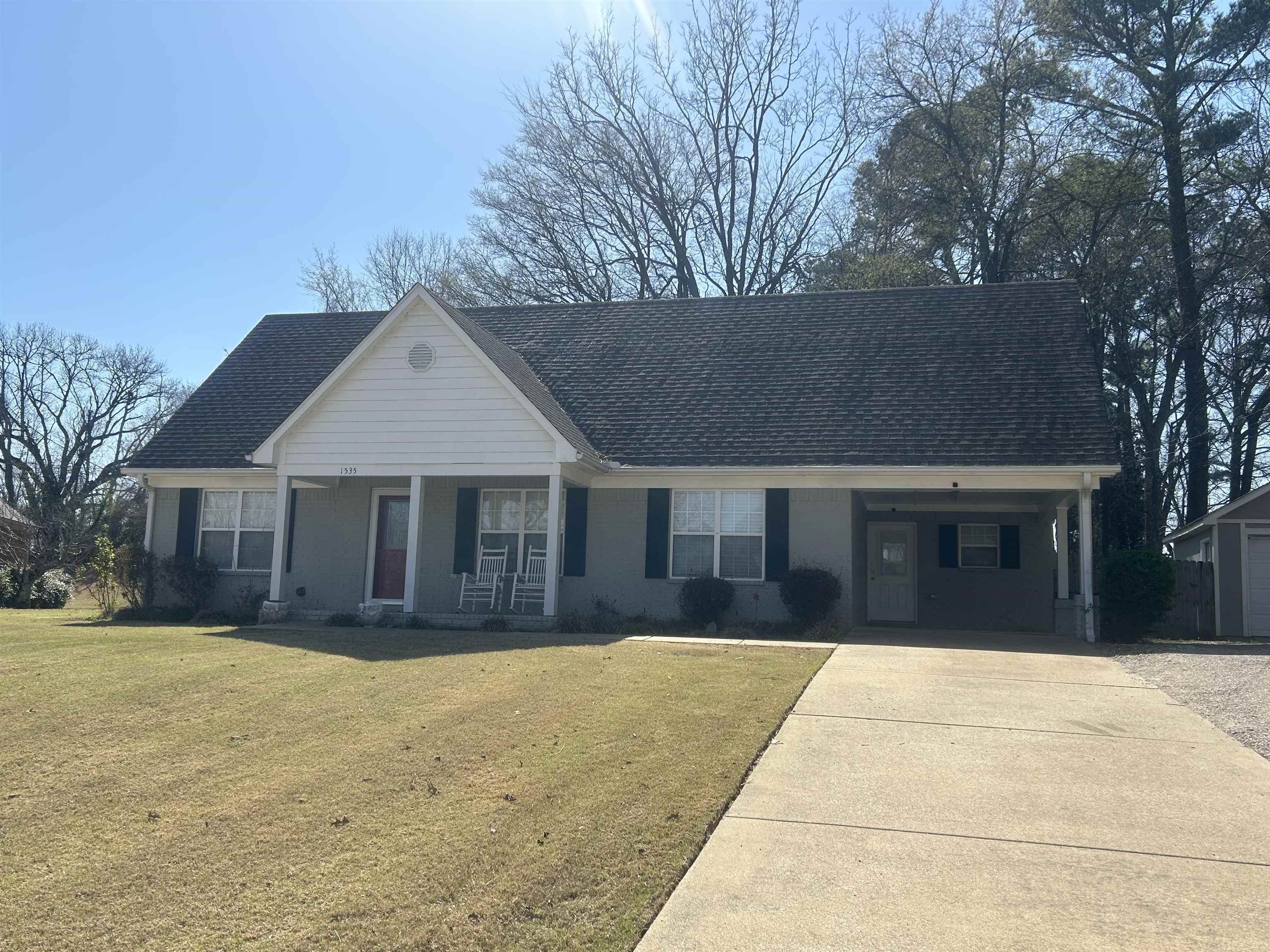 1535 Roane Street Covington, TN 38019 - Photo 3 of 25 View of front of home featuring covered porch, a front lawn, and a shingled roof