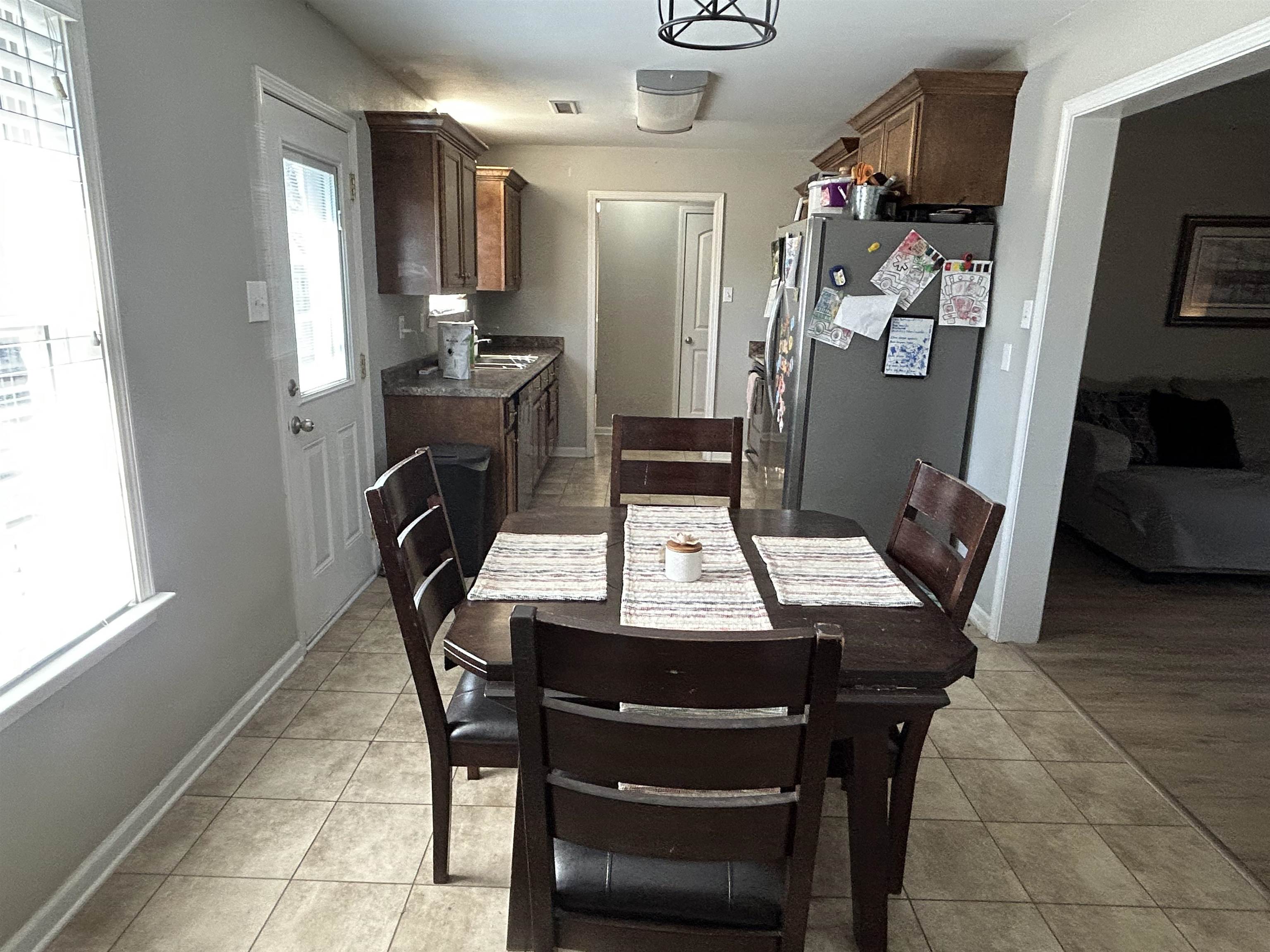 1535 Roane Street Covington, TN 38019 - Photo 6 of 25 Dining space featuring light tile patterned floors and baseboards