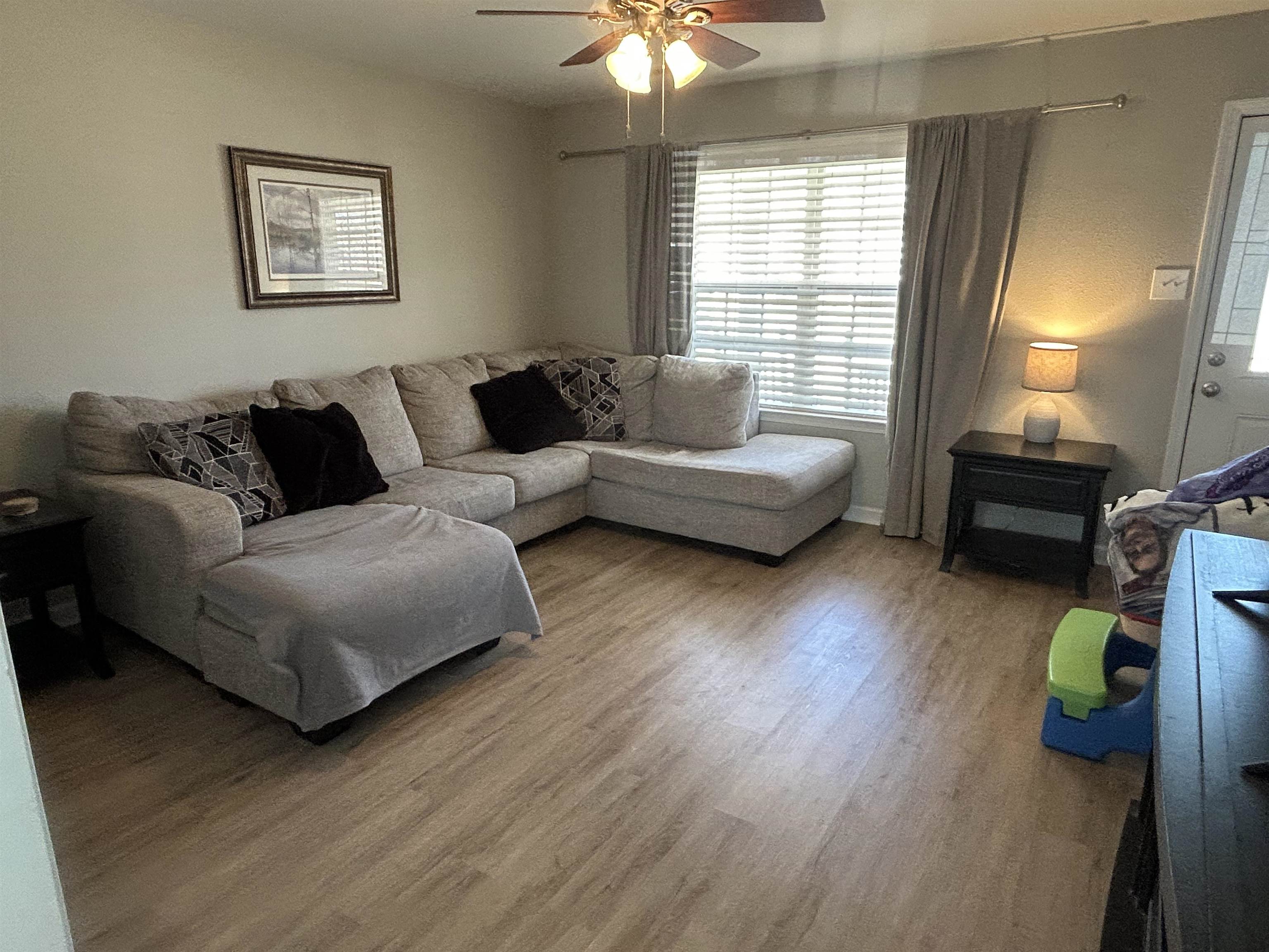 1535 Roane Street Covington, TN 38019 - Photo 7 of 25 Living area featuring ceiling fan and wood finished floors