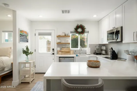 a kitchen with sink a stove and cabinets