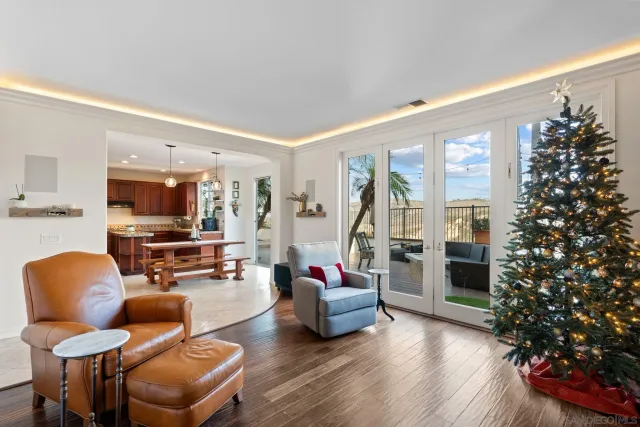 a open kitchen with stainless steel appliances granite countertop a sink dishwasher a dining table and chairs with wooden floor