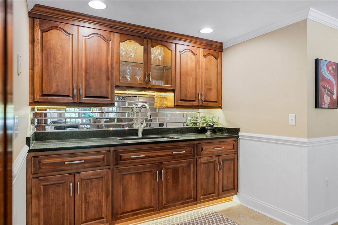 200 Graylyn Drive Anderson, SC 29621 - Photo 33 of 48 Custom cabinetry and elegant mirrored backsplash create a refined wet bar perfect for entertaining.