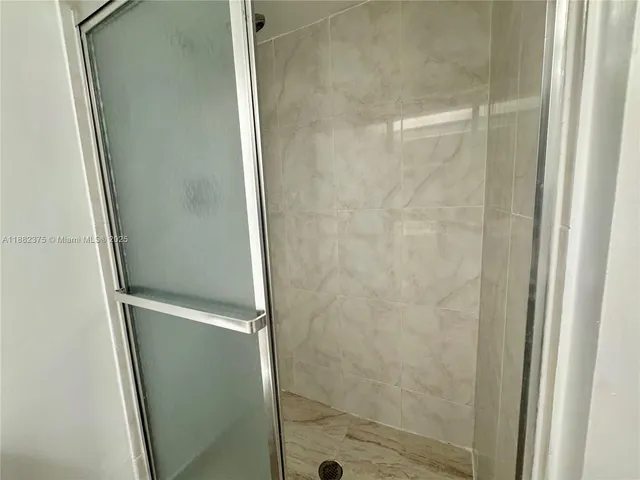 a bathroom with a glass shower door