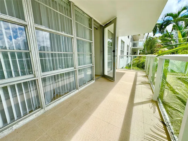 a view of balcony with floor to ceiling windows and wooden floor