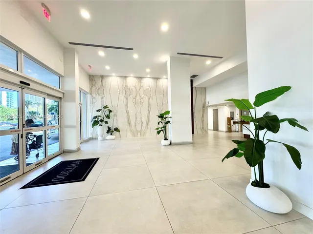 a lobby with furniture and potted plant