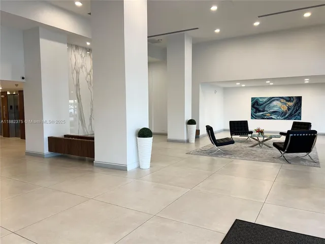 a lobby with furniture and a mirror