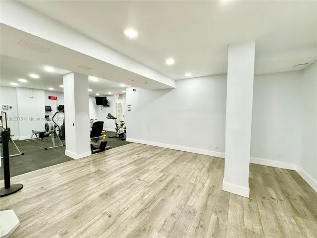 a bathroom with a mirror and cabinets