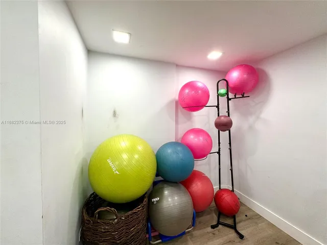 a room with pool table and windows