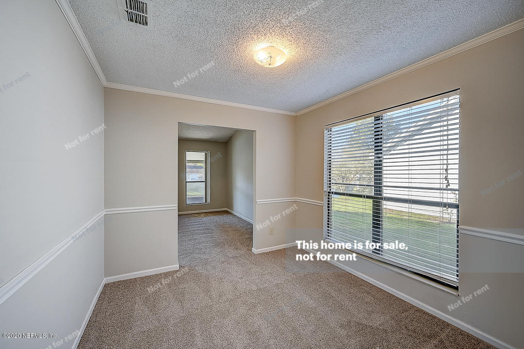 8864 Cherry Hill Drive Jacksonville, FL 32221 - Photo 16 of 17 an empty room with windows and entrance
