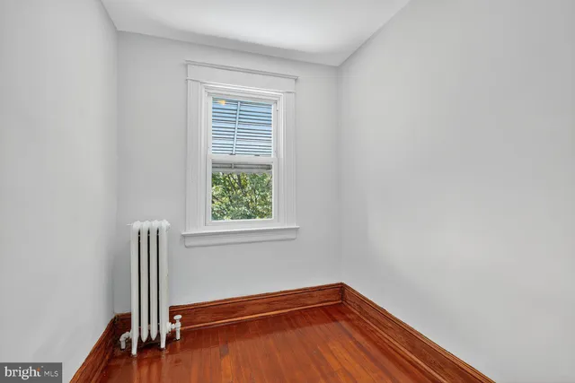 a view of a room with wooden floor and a window