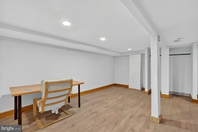 a view of an empty room with wooden floor