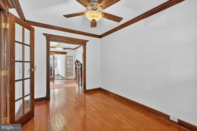 a view of empty room with wooden floor