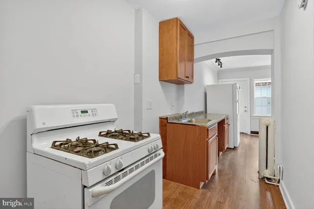 a kitchen with a stove and a refrigerator