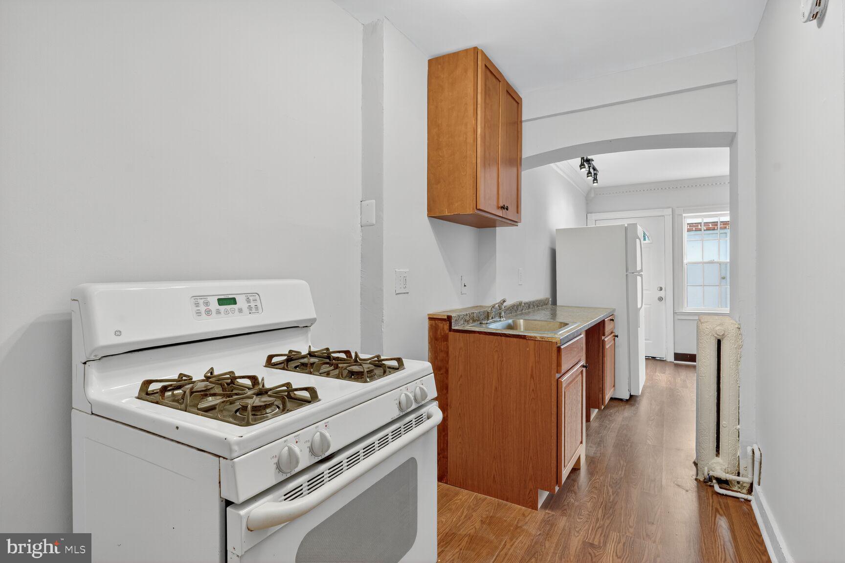 2731 4th Street Northeast Washington, DC 20002 - Photo 7 of 20 a kitchen with a stove and a refrigerator
