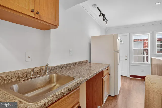 a kitchen with a sink and a refrigerator