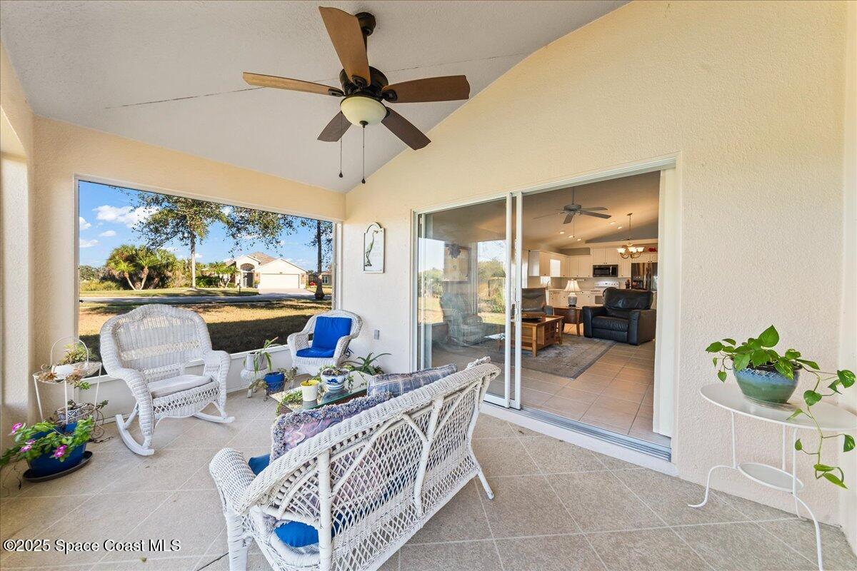 1404 Boca Rio Drive Melbourne, FL 32940 - Photo 11 of 53 a living room with furniture and a floor to ceiling window