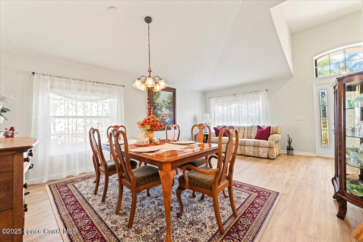 1404 Boca Rio Drive Melbourne, FL 32940 - Photo 14 of 53 a view of a dining room with furniture window and wooden floor