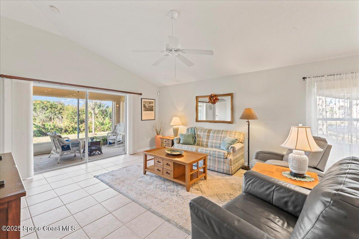1404 Boca Rio Drive Melbourne, FL 32940 - Photo 20 of 53 a living room with furniture and large windows