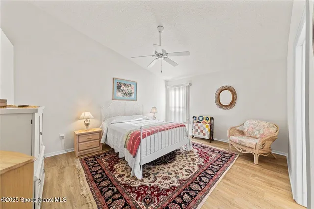 a bedroom with a bed and chandelier