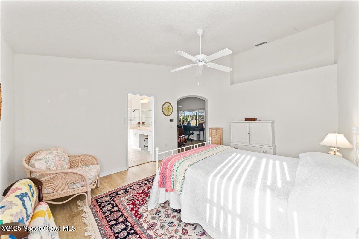 1404 Boca Rio Drive Melbourne, FL 32940 - Photo 26 of 53 a bedroom with a bed and chandelier