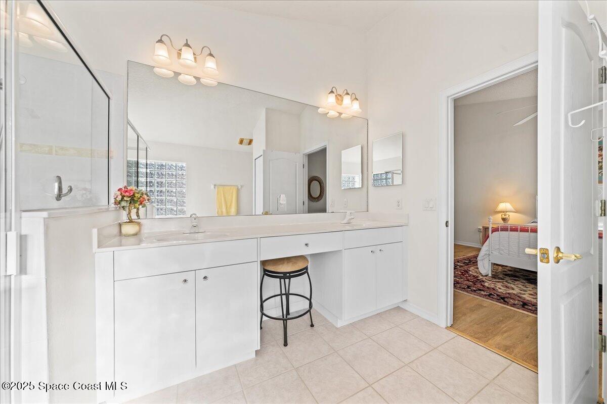1404 Boca Rio Drive Melbourne, FL 32940 - Photo 28 of 53 a spacious bathroom with a sink double vanity and a mirror