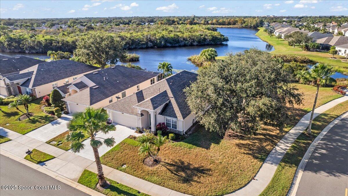 1404 Boca Rio Drive Melbourne, FL 32940 - Photo 3 of 53 an aerial view of a house with a yard and lake view