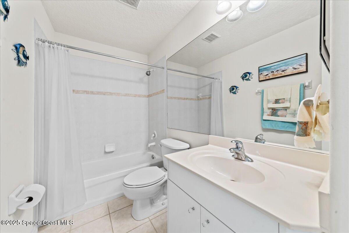 1404 Boca Rio Drive Melbourne, FL 32940 - Photo 31 of 53 a bathroom with a sink toilet a mirror and shower