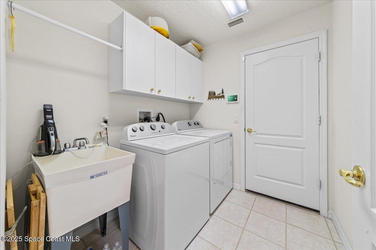 1404 Boca Rio Drive Melbourne, FL 32940 - Photo 32 of 53 a utility room with dryer and washer
