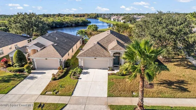 an aerial view of a house with a yard