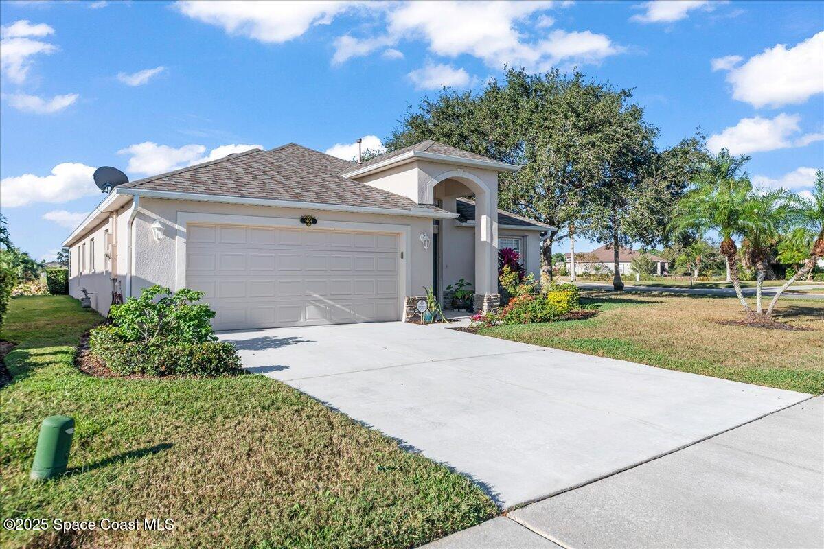 1404 Boca Rio Drive Melbourne, FL 32940 - Photo 6 of 53 a front view of a house with a yard and potted plants