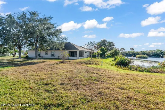a house view with swimming pool in front of it