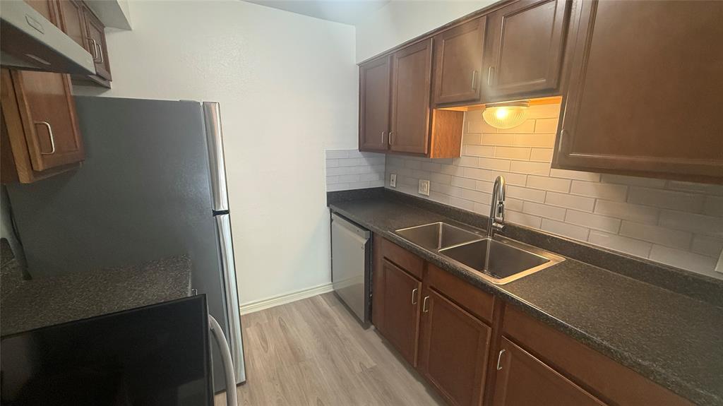500 East Riverside Drive, Unit 132 Austin, TX 78704 - Photo 4 of 31 a kitchen with stainless steel appliances granite countertop a sink a refrigerator and a stove