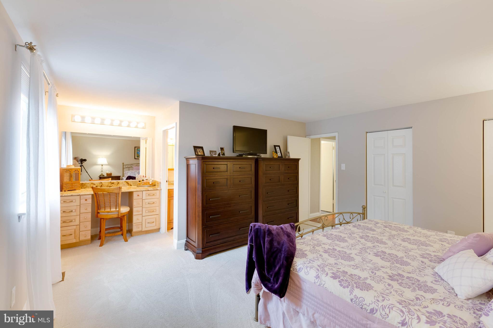 11204 Chestnut Grove Square, Unit 305 Reston, VA 20190 - Photo 14 of 21 a bed room with a bed and furniture
