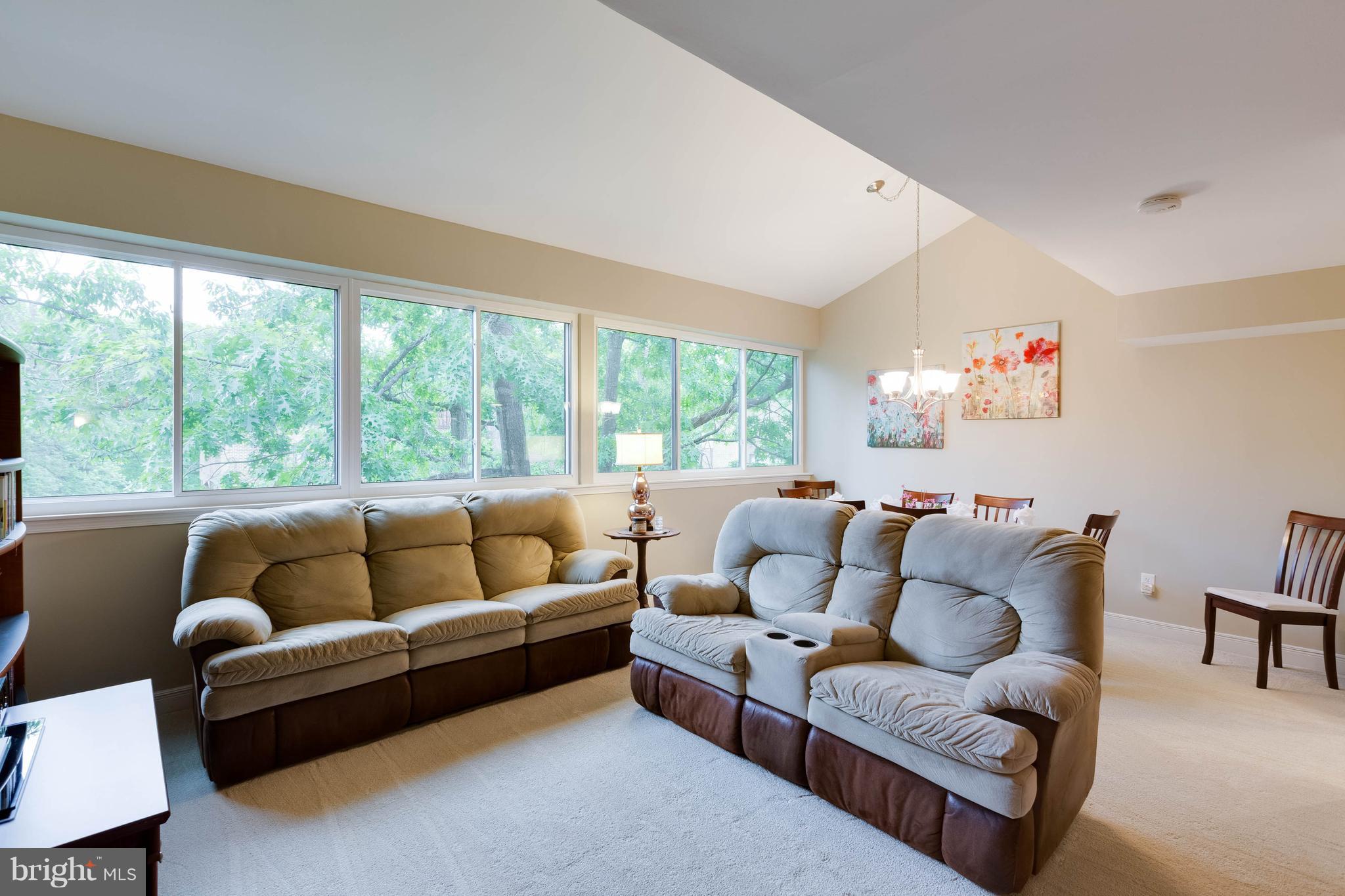 11204 Chestnut Grove Square, Unit 305 Reston, VA 20190 - Photo 3 of 21 a living room with furniture and a large window