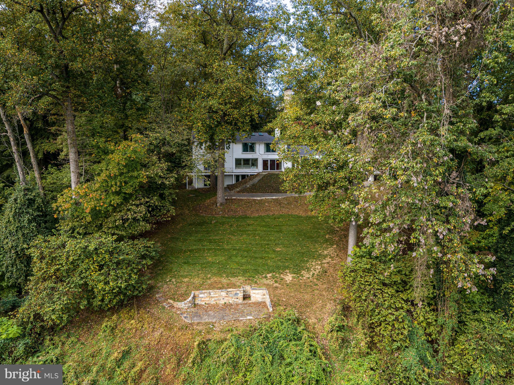 1175 Crest Lane McLean, VA 22101 - Photo 5 of 13 a backyard of a house with a yard and outdoor seating