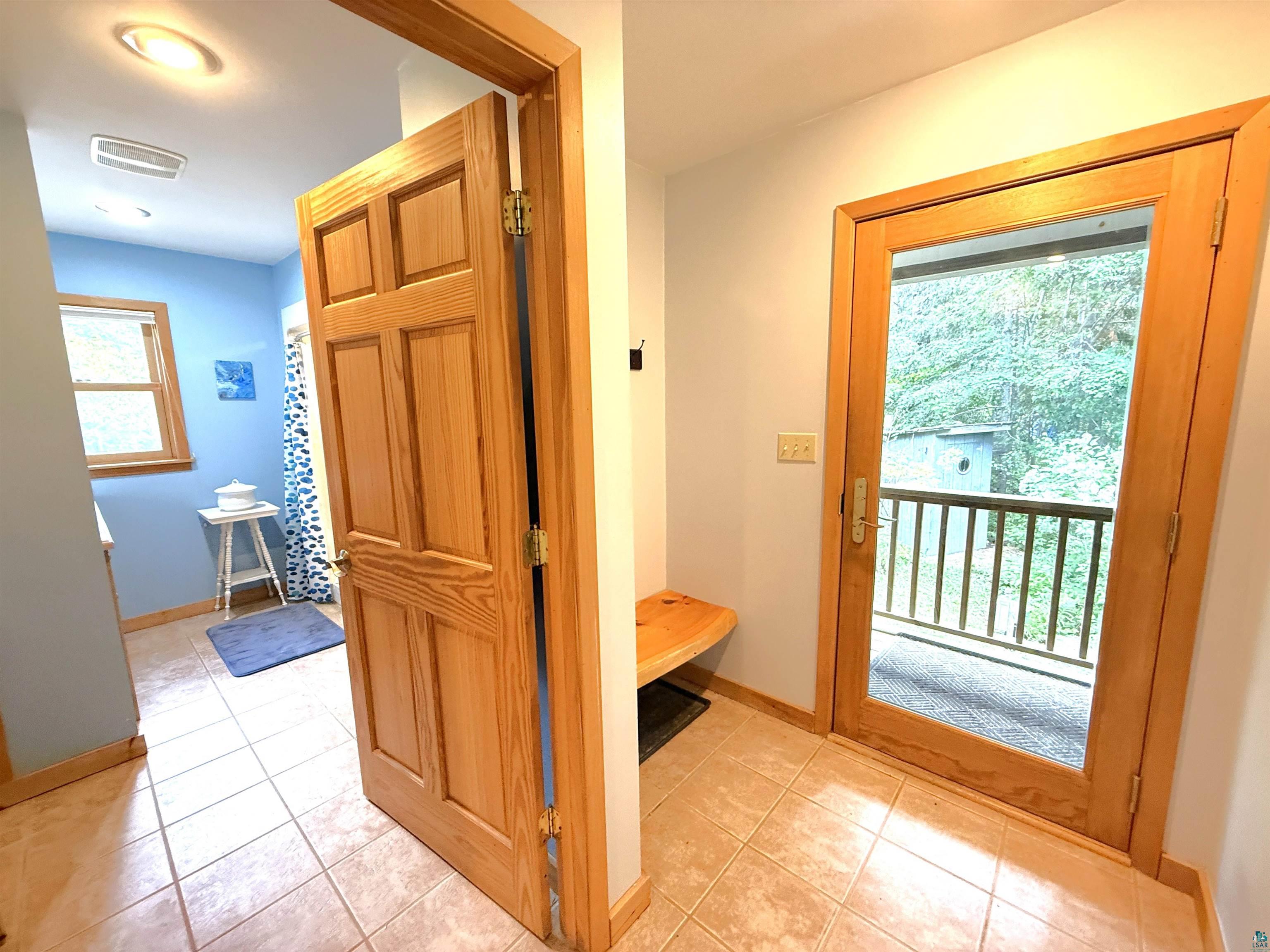 1787 North Bay Road Ely, MN 55731 - Photo 21 of 40 Full-light wood-frame door opening to an exterior balcony with wooden railing
