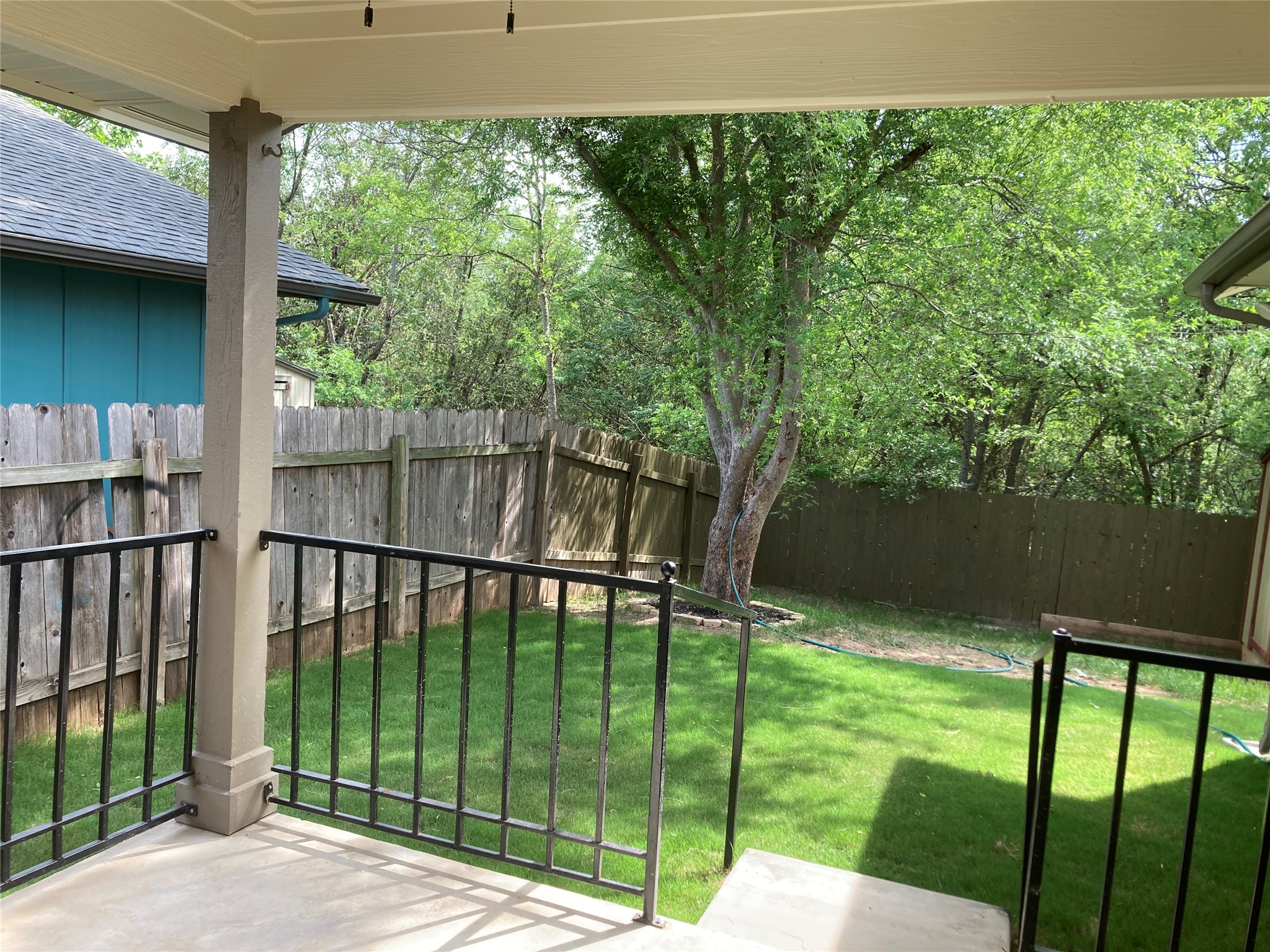 7307 Thannas Way Austin, TX 78744 - Photo 6 of 13 Fenced backyard with a patio area
