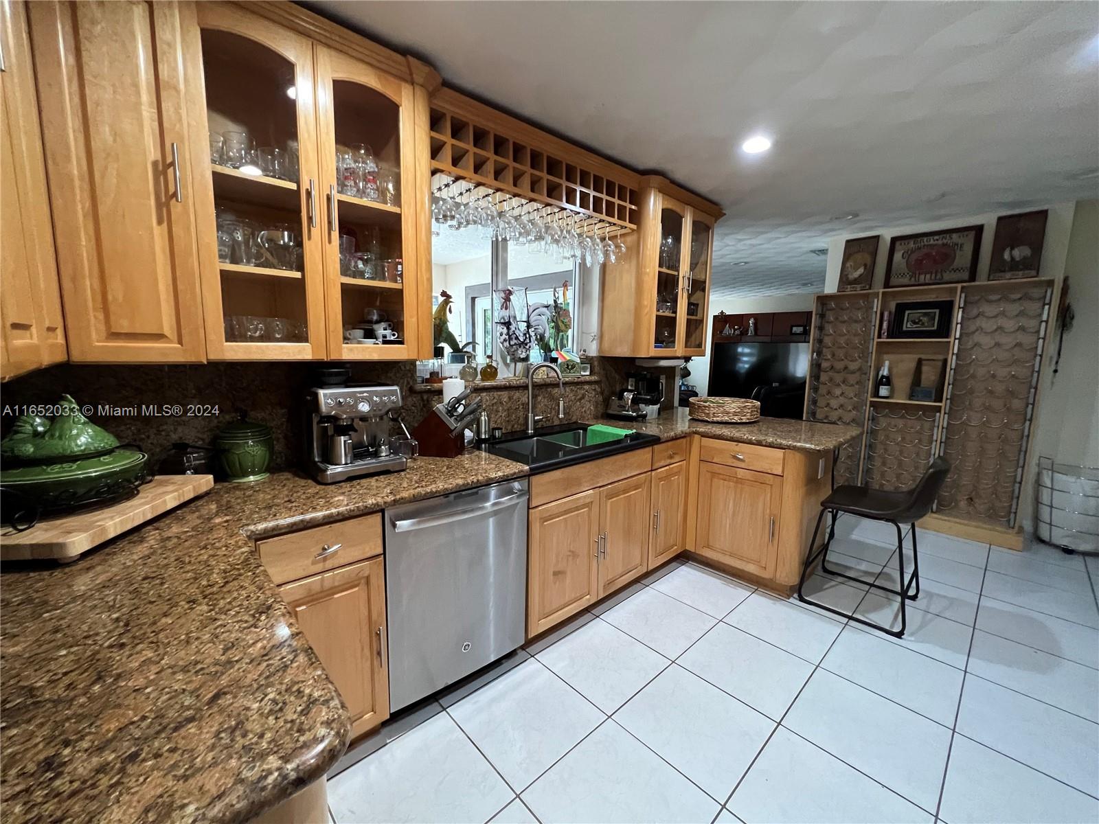 11866 Southwest 43rd Street Miami, FL 33175 - Photo 28 of 64 a kitchen with stainless steel appliances kitchen island granite countertop a stove a sink and a microwave