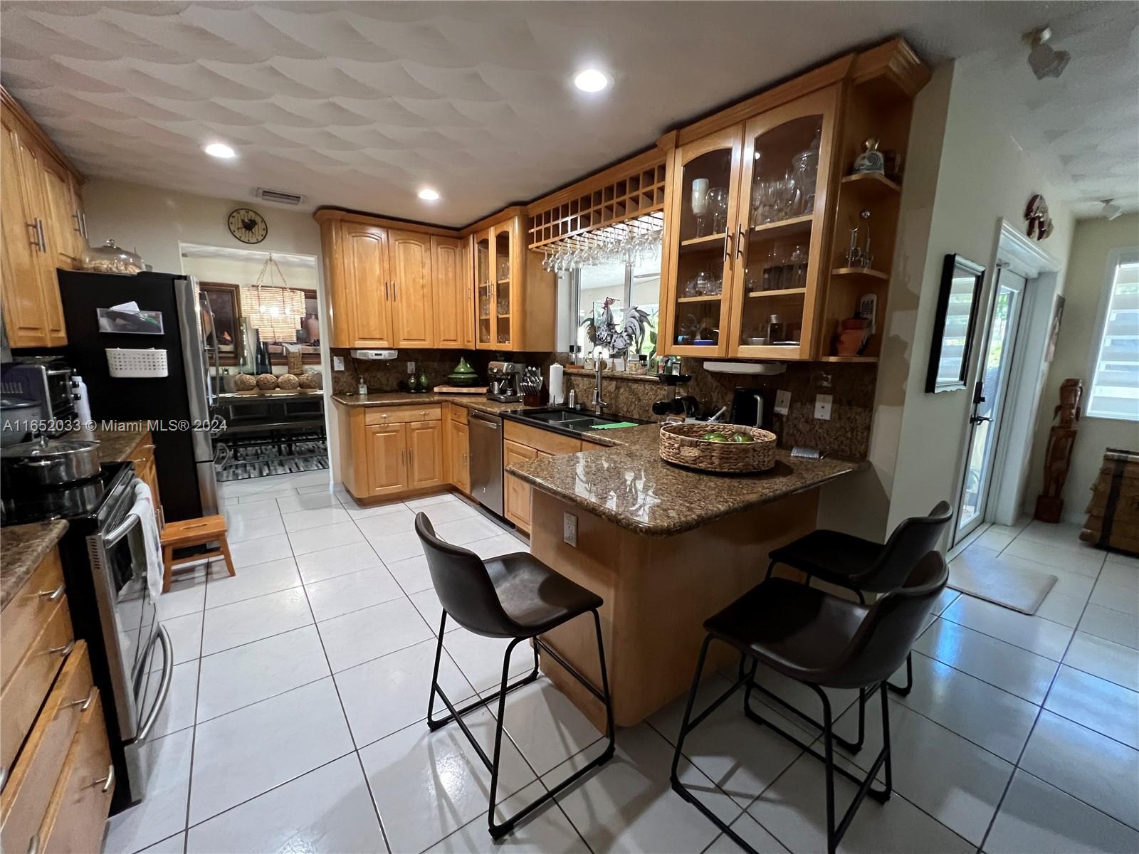 11866 Southwest 43rd Street Miami, FL 33175 - Photo 30 of 64 a kitchen with a dining table and chairs