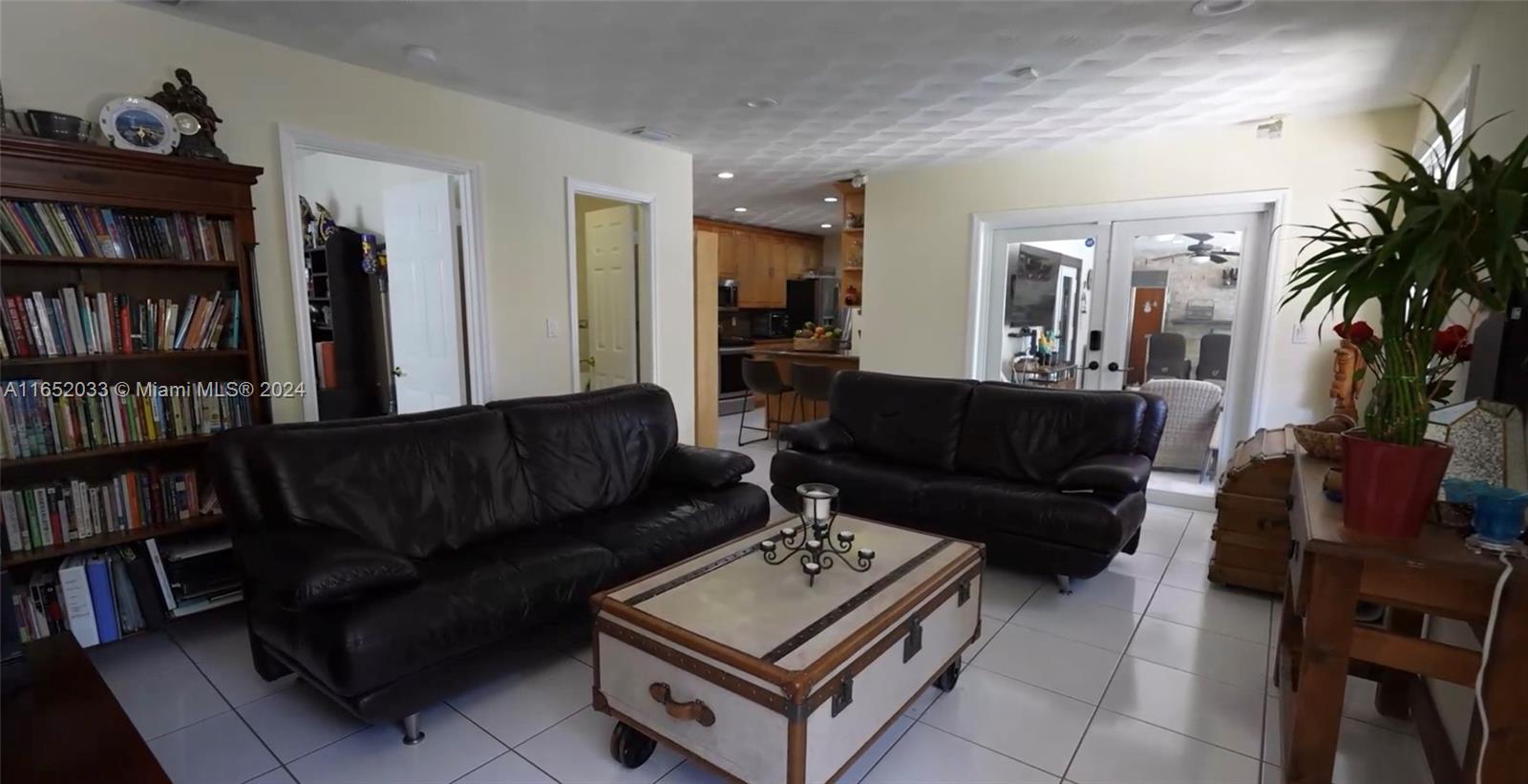 11866 Southwest 43rd Street Miami, FL 33175 - Photo 32 of 64 a living room with furniture and a book shelf