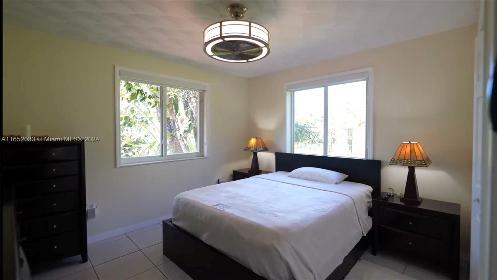 11866 Southwest 43rd Street Miami, FL 33175 - Photo 35 of 64 a bedroom with a bed and a window