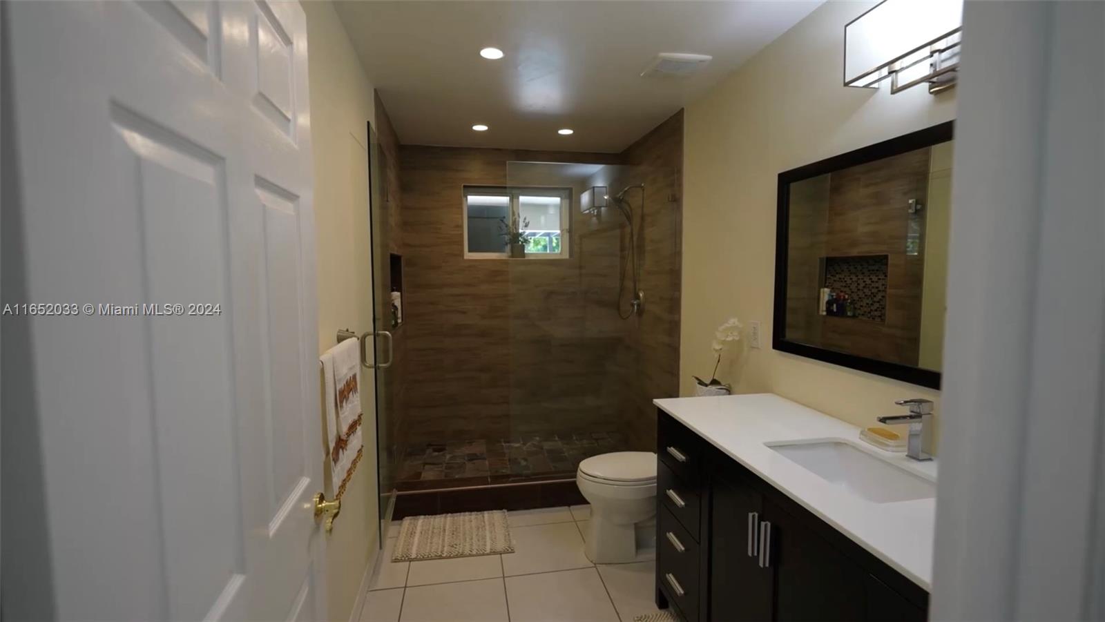 11866 Southwest 43rd Street Miami, FL 33175 - Photo 36 of 64 a bathroom with a sink a toilet and shower