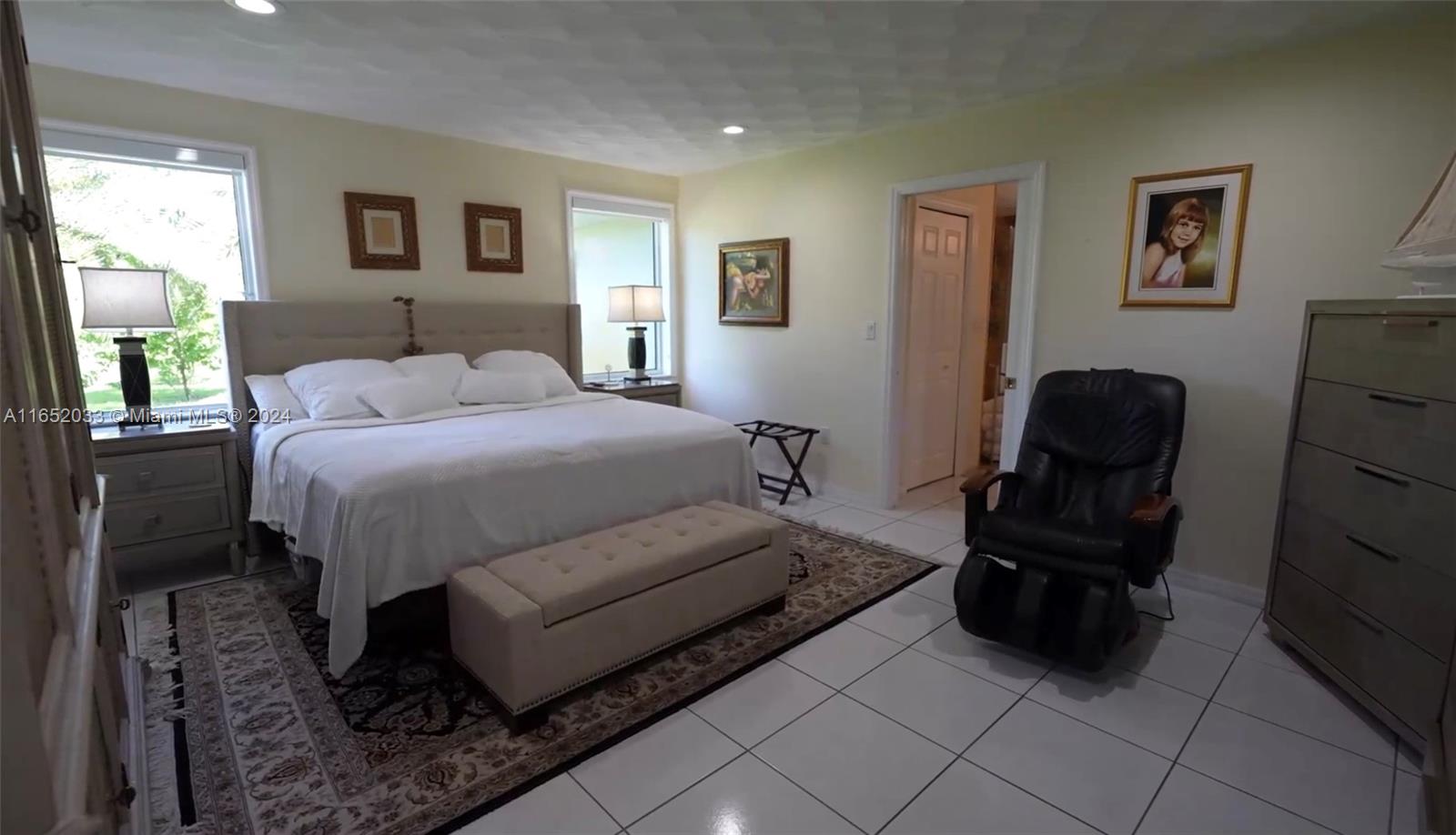 11866 Southwest 43rd Street Miami, FL 33175 - Photo 38 of 64 a bedroom with a bed and a chair