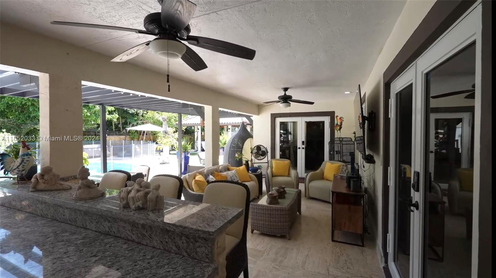 11866 Southwest 43rd Street Miami, FL 33175 - Photo 41 of 64 a living room with furniture ceiling fan and a large window