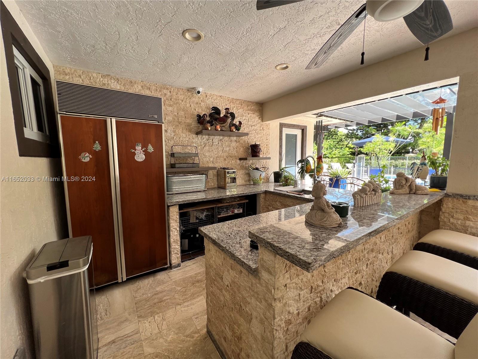 11866 Southwest 43rd Street Miami, FL 33175 - Photo 42 of 64 a view of kitchen with kitchen island stainless steel appliances sink stove and refrigerator