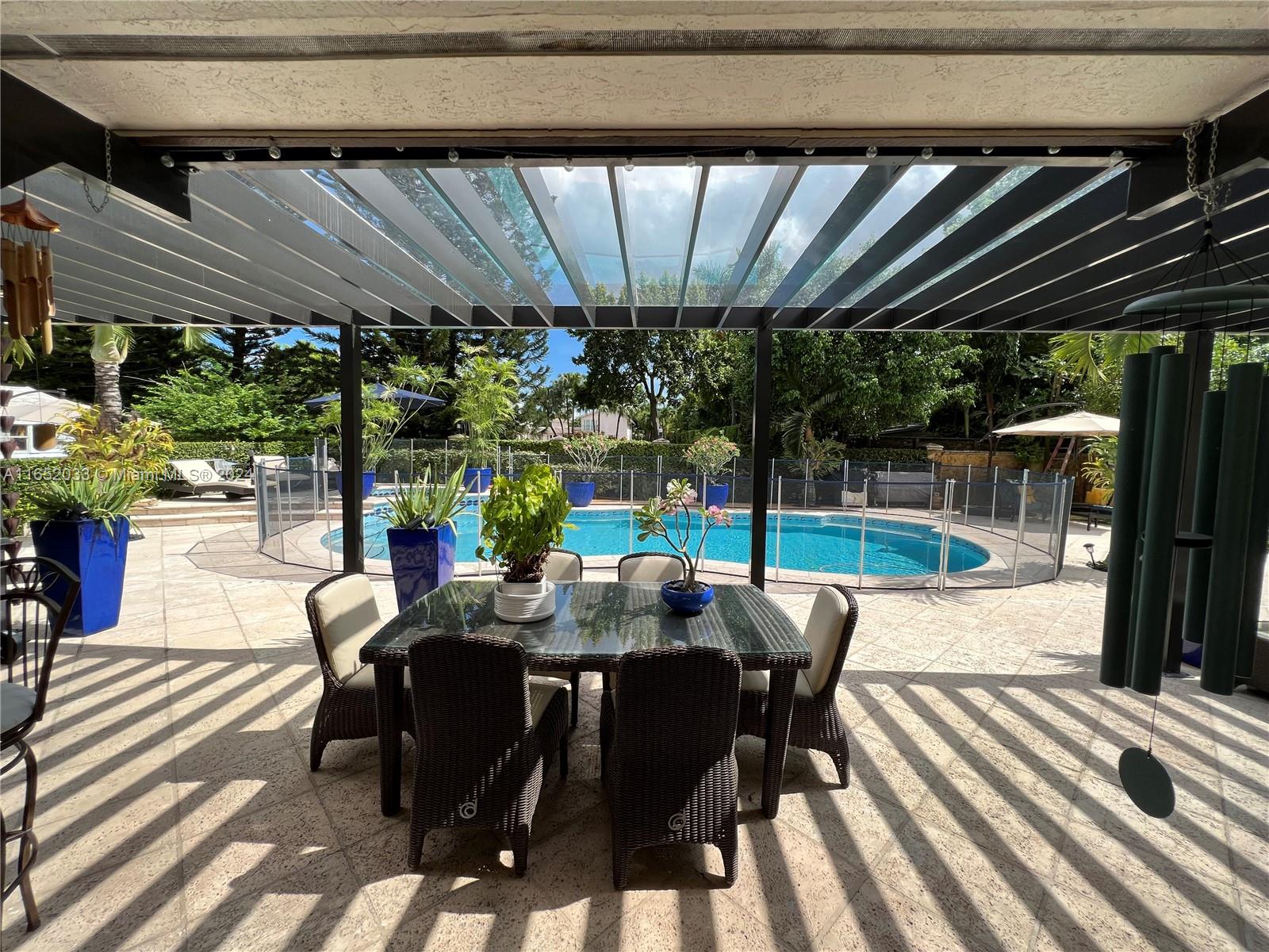 11866 Southwest 43rd Street Miami, FL 33175 - Photo 45 of 64 a view of a patio with a table and chairs and couches